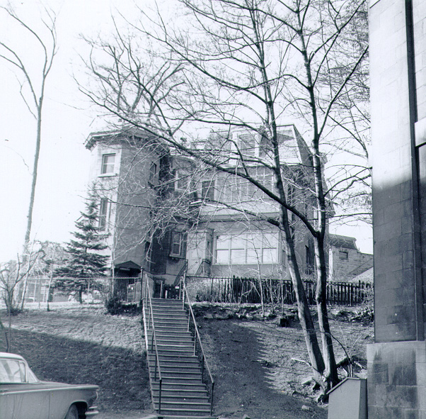 In 1856 Charles Smallwood was welcomed in the McGill community as an Honorary Professor of Meteorology. Although he did not possess a degree in this specific field, he had been recording the weather and rainfall every six hours each day since 1833. So dedicated was he to this empirical study that in 1846 he had built an observatory for himself at his home in St. Martin near Laval. He was thus more than qualified to instruct students on the subject of Meteorology. In 1863, McGill built a stone tower on a bluff just behind the Molson wing of the Arts Building and Professor Smallwood's instruments were incorporated within. In the 1870's, C. H. MacLeod was recruited to assist the aging Professor Smallwood with his studies and, after Smallwood's death in 1873, MacLeod continued to telegraph the daily report to Toronto's Canadian Meteorological Service and took over Smallwood's studies. A few years later, McGill attached a house to the Observatory for MacLeod, now a professor, and his family. In 1874, MacLeod determined the Observatory's exact longitude using telegraph signals and was subsequently asked to wire the time daily to the railways, harbours, and government buildings in Ottawa. All of Canada set their watches by McGill's time for many years and the railways were still using the signal in the 1960's. Unfortunately, in 1963 McGill needed to expand the Arts Building and the Observatory was demolished to be replaced by the Stephen Leacock Building. Set into the floor of this new concrete edifice are a copper square and a plaque on the wall that commemorate the Observatory and its achievements.