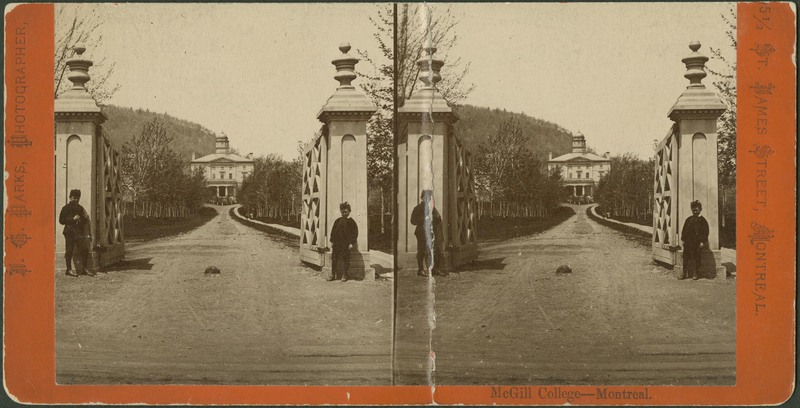 Stone gate entrance to campus with Arts in the background (1865)  