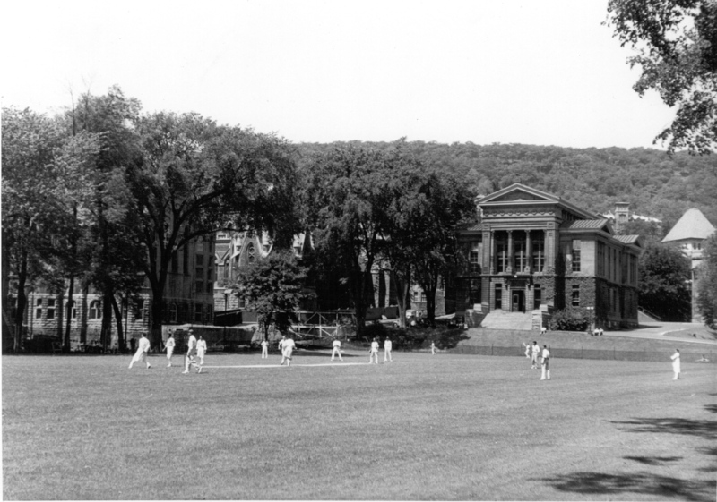 Redpath Library Building, Morrice Hall and Redpath Museum with student cricket players (1952)