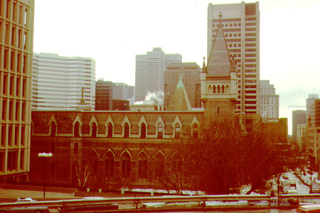 In the 1890's, the Arts Building was becoming more and more crowded as enrolment climbed and new faculties were added to the University. Thus, in 1893, the Applied Science Faculty, as Engineering was then called, was relocated to a new home consisting of two structures, one donated by Thomas Workman and one by Sir William Macdonald, one of McGill's most generous benefactors.

The site chosen for the new additions to the campus was just southeast of the Arts Building, near University Street. The architect commissioned for both was Sir Andrew Taylor and his partner at that time, William Gordon. In designing the Workman Workshops, Taylor kept in mind that it was to be used as the machine and technical shops and as such needed to be sturdy, functional, and not overly ornamented. In keeping with these ideas, the lower three storeys were constructed of rough hewn Montreal limestone. After the Old Medical Building burned down on April 16, 1907, some of its stone was used to add a fourth storey with rounded arched windows to the Workman Workshops. The proportions of the structure are well suited to laboratories housing large machines. In 1947, this building was changed considerably. A fifth floor was added in finished stone by McDougall, Fleming, and Smith, and the labs were transformed into office and classroom spaces.

Taylor's imposing, five-storey Macdonald Engineering Building featured a symmetrical, Italian Renaissance facade and was, like most of the campus, constructed of Montreal limestone on the exterior. The interior was lined with brick and was purely functional, containing on the ground floor a foundry, a forge, a steam and thermodynamics lab, a dynamo and engine room, and a hydraulics lab. The first floor housed a pattern shop, a wood shop, electrical equipment, and some offices. Most of the offices and classrooms were located on the second floor. The third floor included a library and an architecture and apparatus museum and the fourth was a studio and drafting room. Unfortunately, this perfectly equipped building was gutted by fire on April 5, 1907. The east wall, three upper storeys, most of the roof, and several professors' works were destroyed. Shortly after this, the Old Medical Building also burned down.

Immediately after the terrible fire, Sir William Macdonald stepped forward once again to offer a new Engineering Building to the University. This is the present Engineering Building was erected on the foundations of Taylor's project, and was designed in 1908 by Percy Erskine Nobbs, the Director of the School of Architecture at the time who was responsible for many other campus developments. The University requested that this structure, in lieu of the fate of Taylor's, be quite fireproof and so Nobbs, like Taylor, had to put function ahead of ornament. Eighty-eight years later this edifice is still standing and is still used by the Faculties of Engineering. It has a layout and plan very similar to Taylor's. Like the old structure, it has a symmetrical facade, this time in a style influenced by Bernard Shaw. It is very practical, but contains some ornament, such as the carving, on the south wall, of a phoenix rising from ashes, a reminder of the fate of Taylor's building and a symbol of rebirth.

In 1926, the Electrical Engineering Wing, built by George Ross, was attached to the east end of the Workman Wing of the Engineering Building. Intended to be used as machine shops it was constructed of brick and had no ornamentation inside or out. It is difficult to see this structure today because it is within an area closed off by the Frank Dawson Adams Building and the McConnell Engineering Building to the east, the Workman Wing to the north, the Macdonald Engineering Building to the west, and the Macdonald Chemistry Building (now called Macdonald-Harrington which houses the School of Architecture and Urban Planning) to the south.