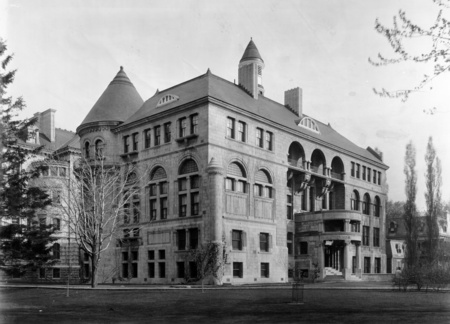 The Macdonald Physics Building was constructed in 1893 by Sir Andrew Taylor, who designed several of the University's projects of the 1890's, and his partners at that time Morley Hogle and Huntley Davis. It was a gift of Sir William Macdonald, the donor of many other edifices on campus including Macdonald Engineering, Macdonald Chemistry, and the Old Student Union (now the McCord Museum). As with many of his other projects, Taylor took into account the function of the building before its ornament, though the latter was not ignored. Knowing the nature of Physics experiments and the current needs of the field, he built the entire edifice using only wood, masonry, and copper, bronze and brass for the nails and fixtures. No iron or steel was used throughout, even in the radiators, to keep magnetic interference at a minimum. The interior is of heavy brick and is constructed in large arches, many of which have since been filled in. Many labs and much apparatus were originally provided for the study of electricity, light, heat, and the elements.

This Richardsonian Romanesque structure has an irregular shape, typical of this picturesque style, with a large tower dominating the northwest corner, yet a symmetrical south facade. It is ornamented in subtle ways by carvings and mottoes placed around the exterior and interior. The portico of what was once the main entrance has two columns stating "Power" and "Knowledge", two necessities of accomplishing any work within the walls. The entrance hall fireplace has a mantelpiece declaring "Prove All Things".

In May, 1903, this motto was challenged by a young Physics professor, Ernest Rutherford. He published and won the Nobel Prize for profound discoveries derived from experiments conducted in the Macdonald Physics Building, concerning the nature of radioactivity and the atom, an event that would have awed both Macdonald and Taylor. Some of the equipment and personal effects of the famous scientist until recently resided in a museum on the top floor. These were moved to the new Ernest Rutherford Physics Building.

A fire broke out in the optics lab in December, 1924 causing $20,000 of damage; fortunately, the edifice was rescued. In 1930, a meteorology station was added to the top of the building and in 1941 a fourth floor was added. In 1982, Taylor's building no longer met the needs of the modern Physics department. It was at this point transformed into the Macdonald-Stewart Library Building of Physical Sciences and Engineering. Its sturdy structure has been well adapted to house many thousands of volumes and it is still regularly filled with physicists doing research.